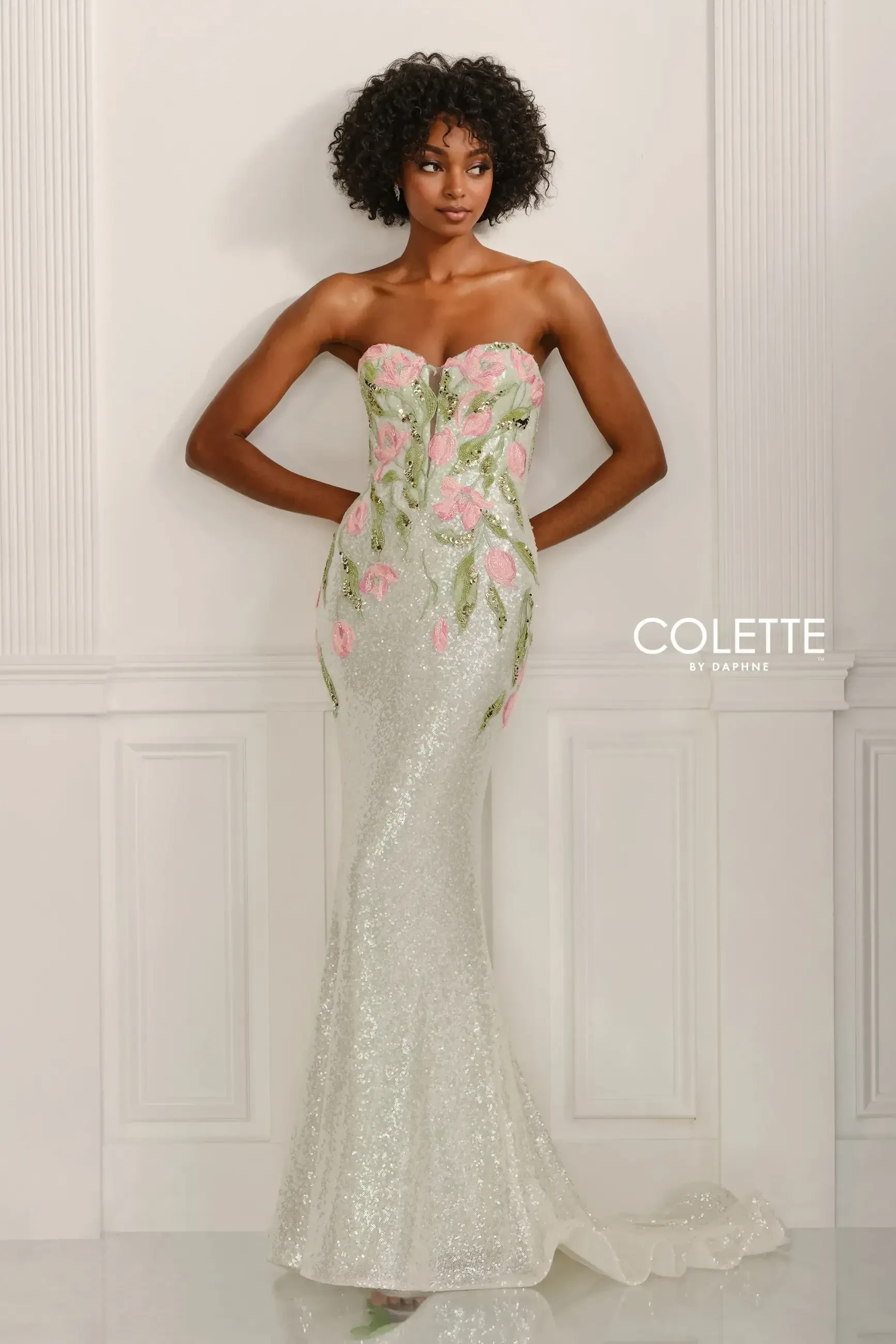 model is wearing a strapless mint prom dress