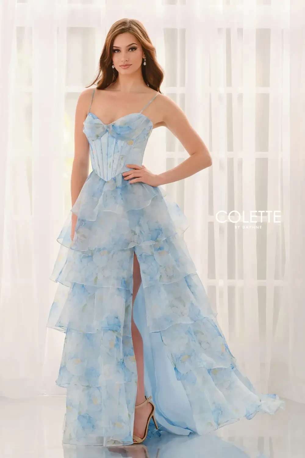 model is wearing a strapless blue prom dress