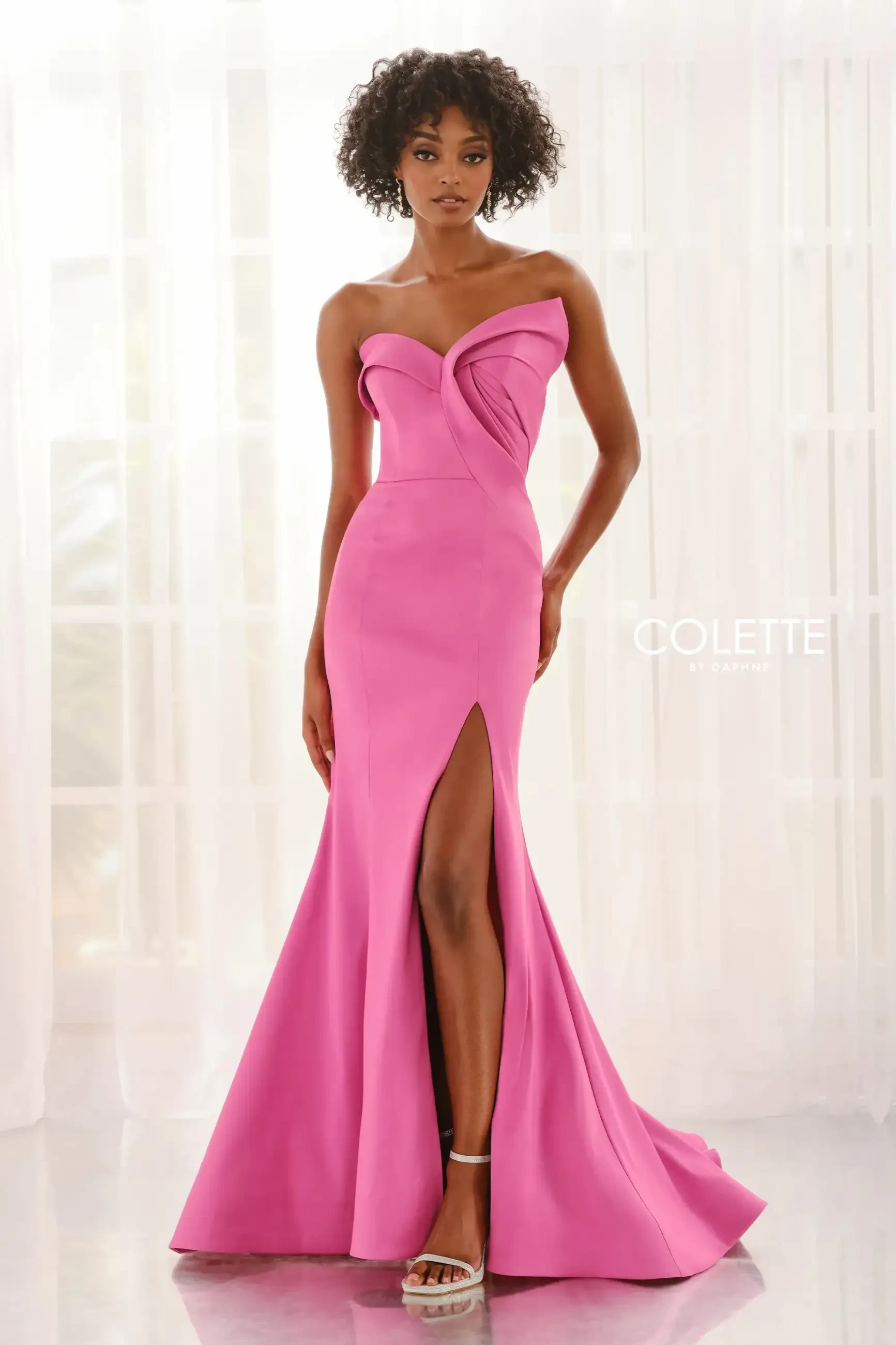 model is wearing a sweetheart pink strapless prom dress