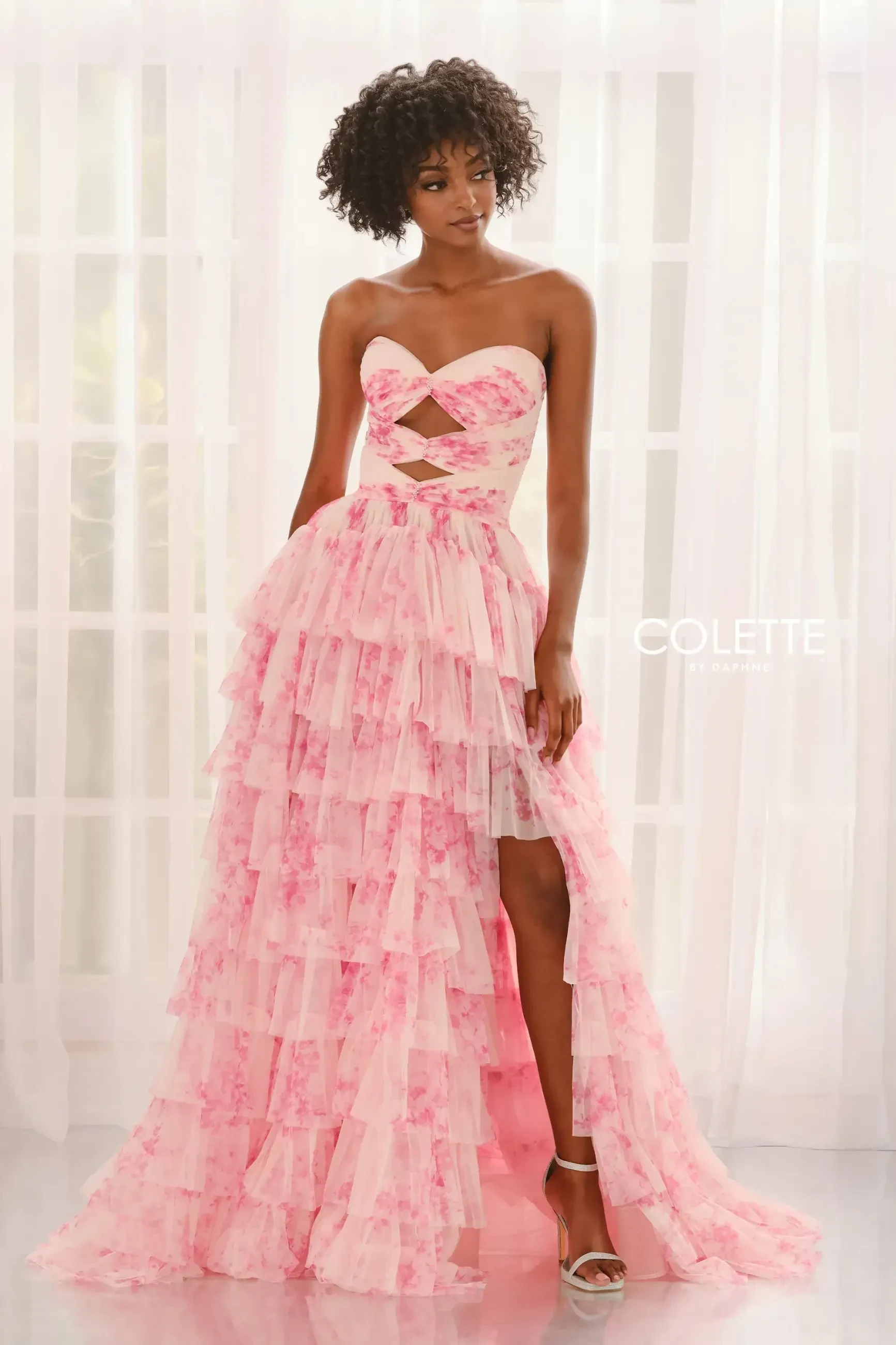 model is wearing a strapless floral a-line prom dress