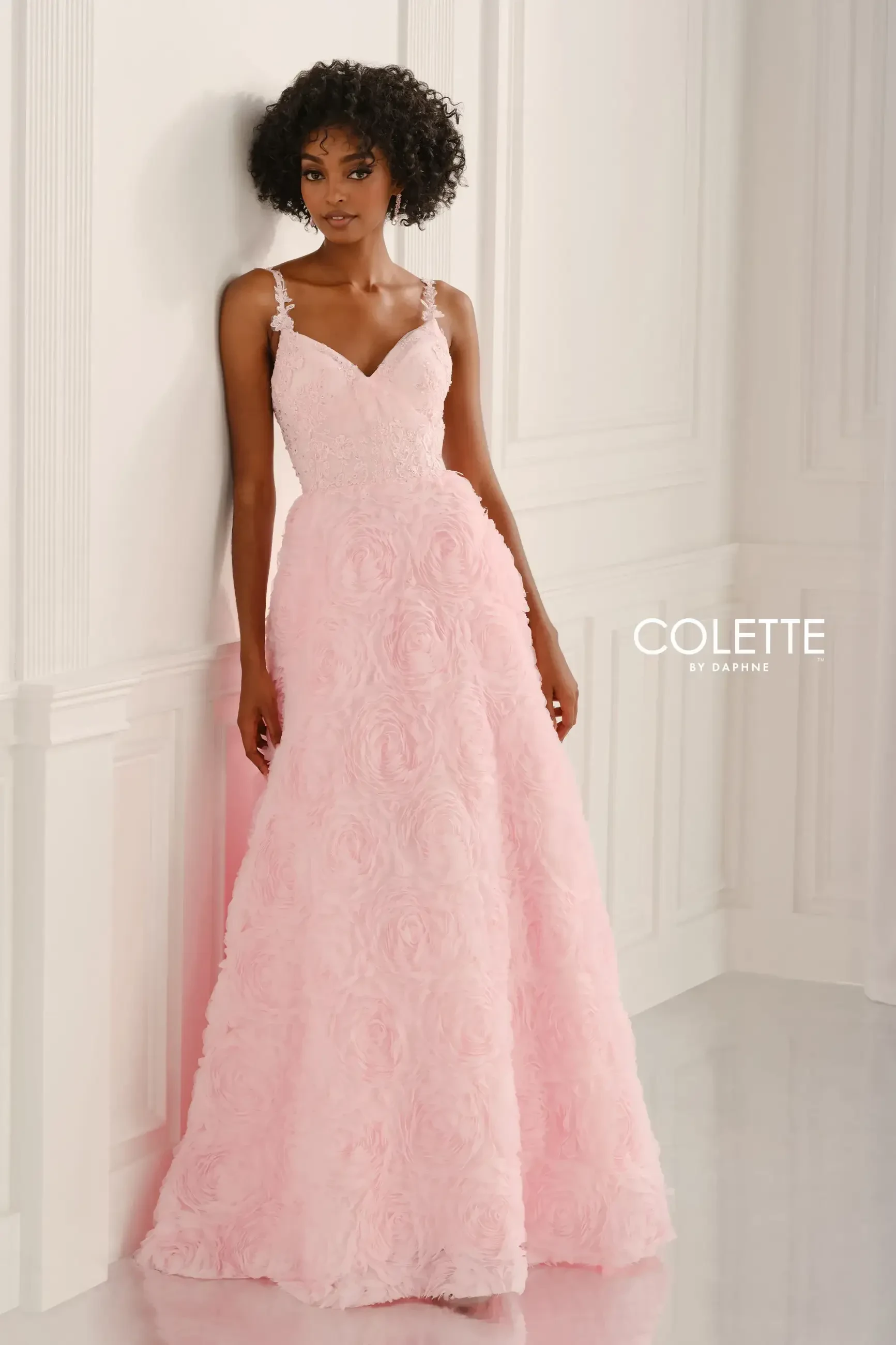 model is wearing a light pink prom dress
