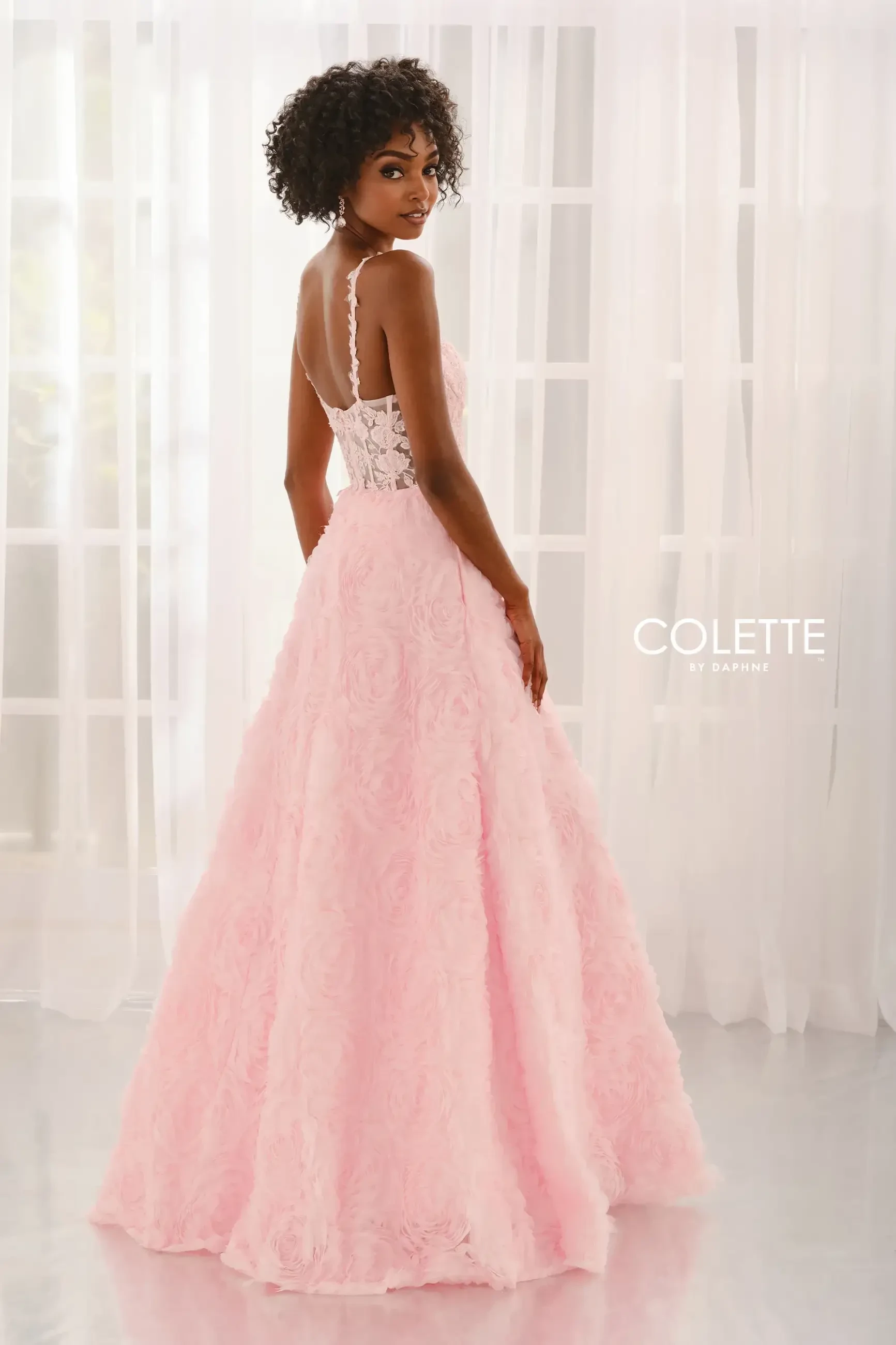 model is wearing a light pink prom dress