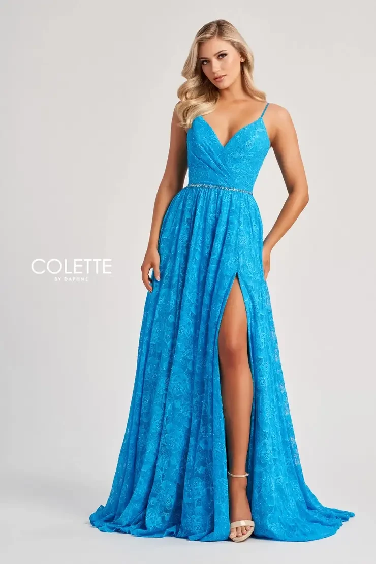 Model is wearing a turquoise dress with an a-line silhouette and thigh high slit