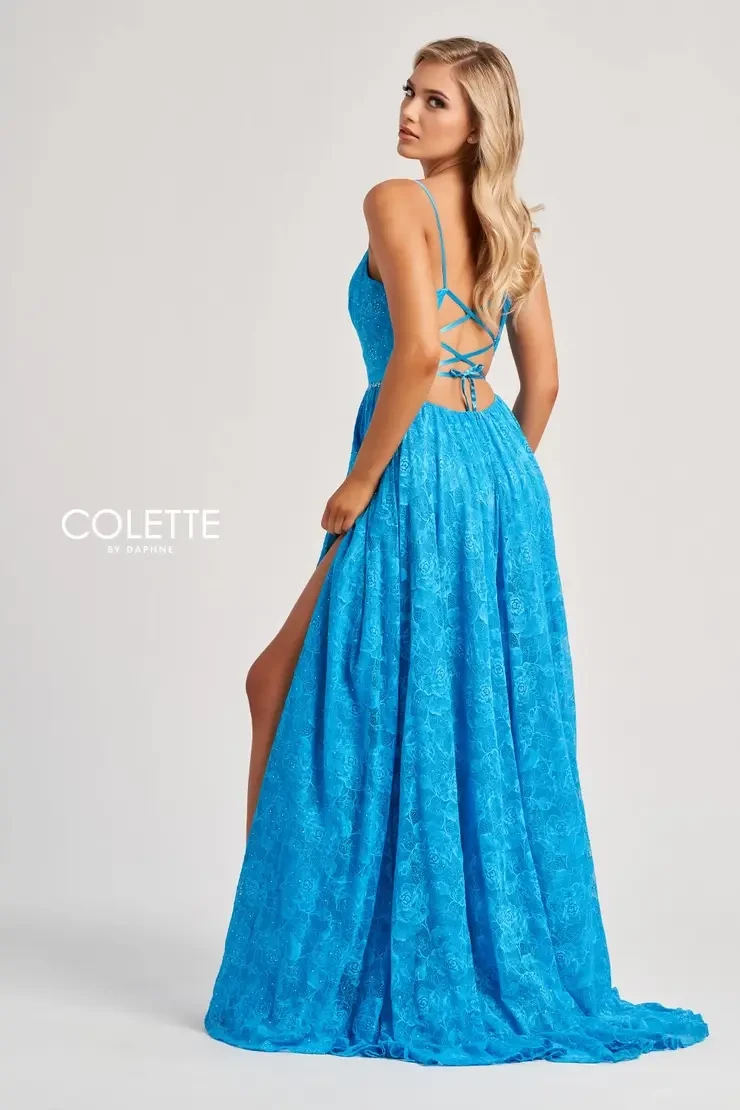 Model is wearing a turquoise dress with an a-line silhouette and thigh high slit