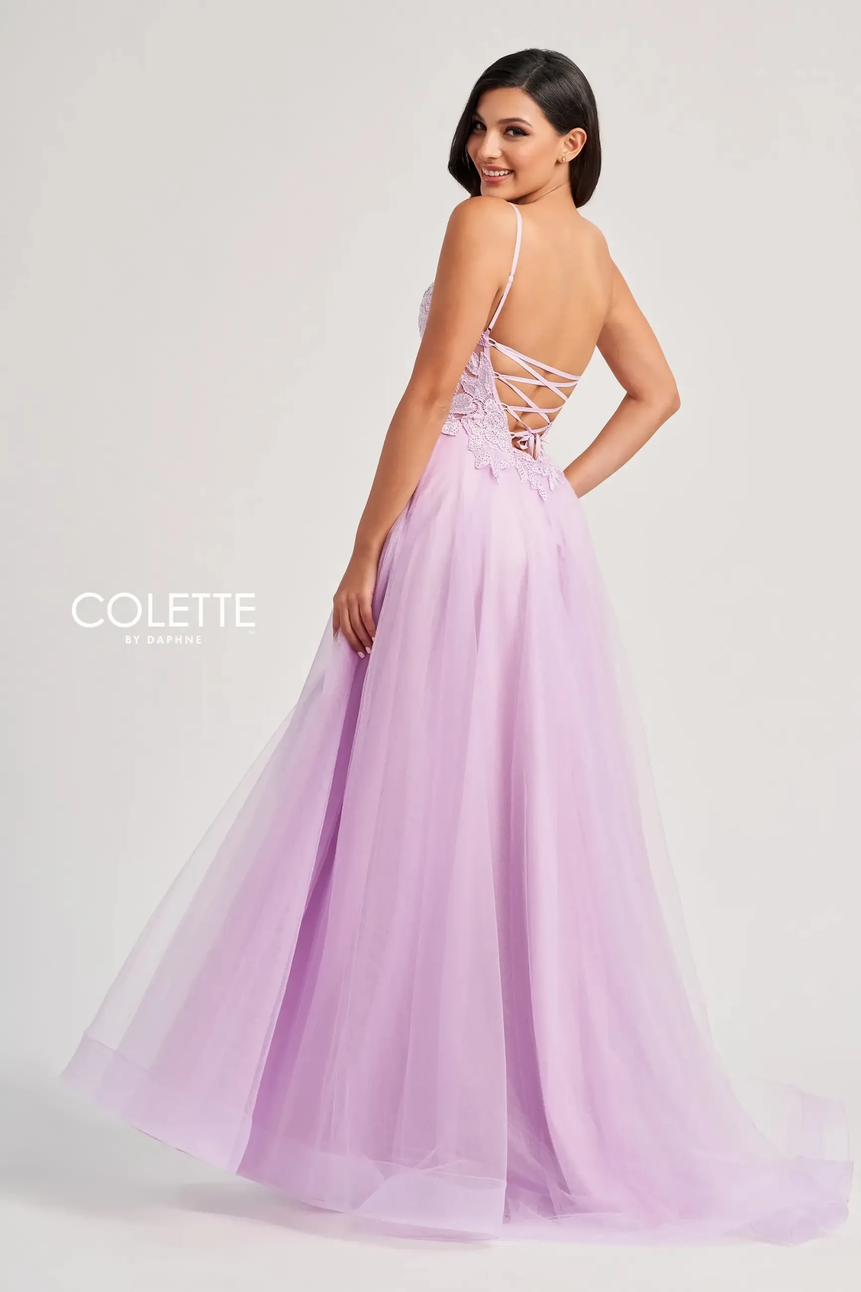Model is wearing a lilac corset evening dress with pockets