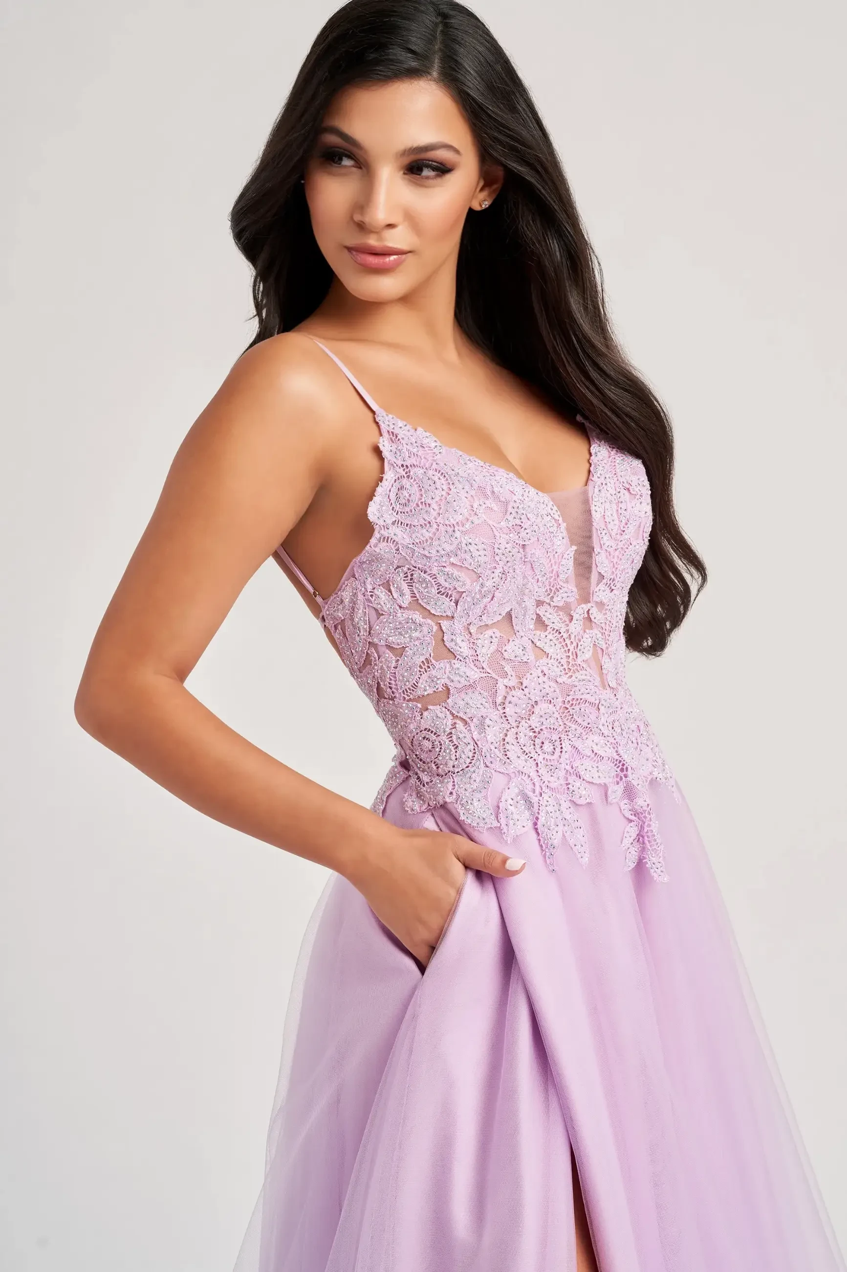 Model is wearing a lilac corset evening dress with pockets