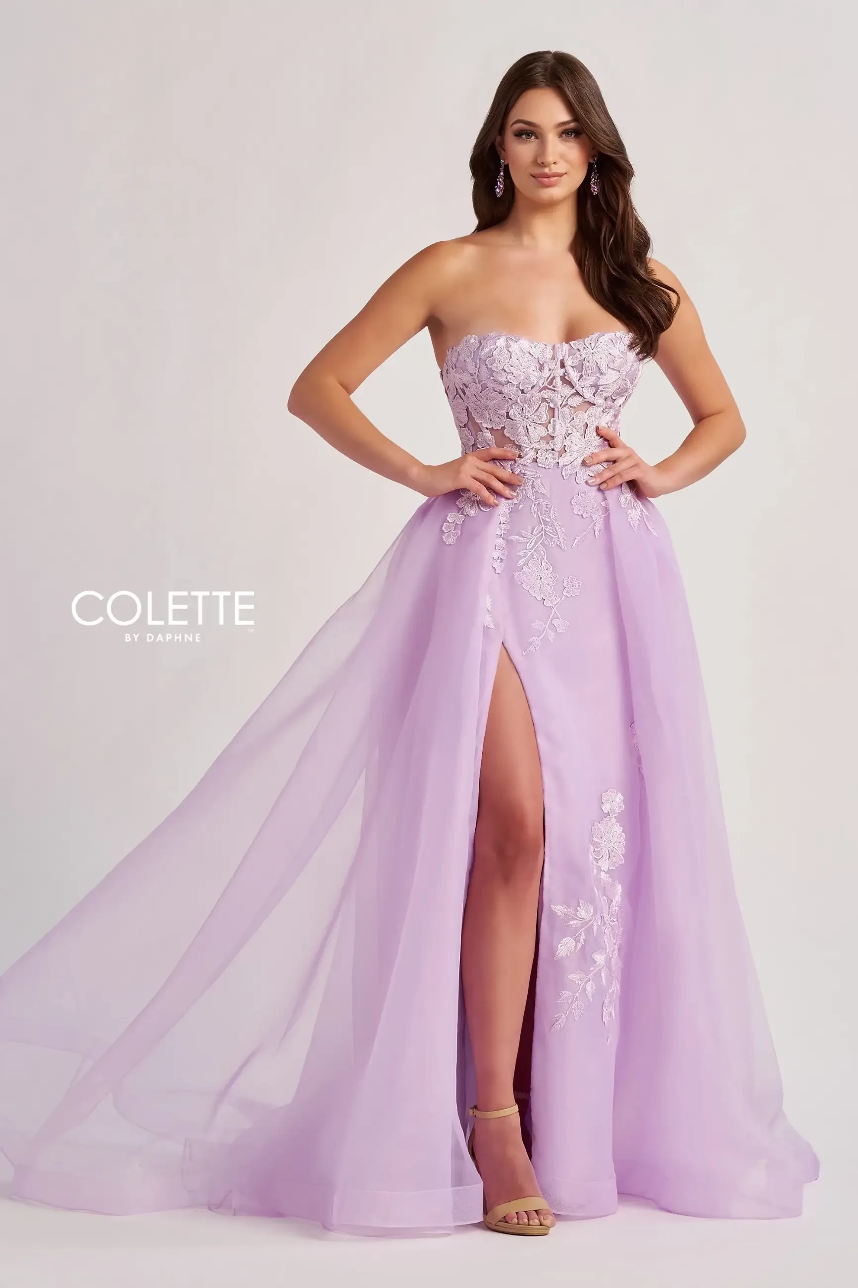 model is wearing a strapless lilac prom dress